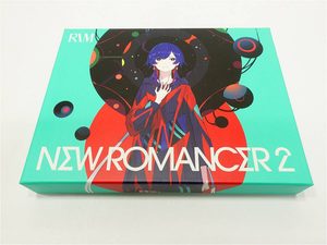 Colorful product box with an anime-style girl in red and blue, turquoise background, text reads NEW ROMANCER 2, likely packaging art.