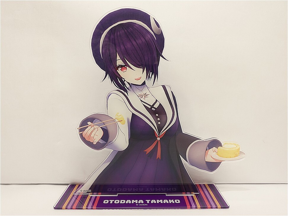 Anime-style figurine of Otodama Tamako in a purple dress, holding chopsticks toward the viewer and a small cake on a plate in her other hand, standing on a striped base with her name visible.