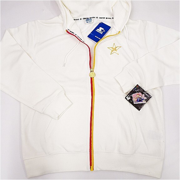 e12134751781 | Vtuberグッズ買取専門店 White zip-up hoodie with a red and yellow zipper, gold star embroidery, and a decorative patch on the sleeve.