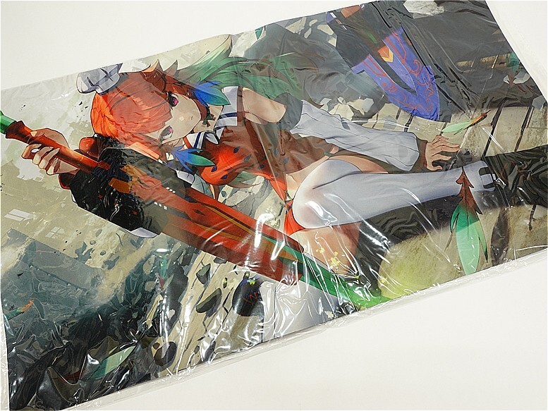 Plastic-wrapped anime poster showing a dynamic female character with orange hair and a large red weapon.