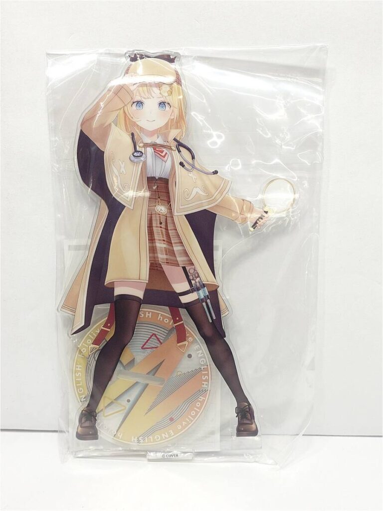 Anime-style female doctor figure in a beige coat with a stethoscope, standing on a circular base, sealed in plastic packaging.
