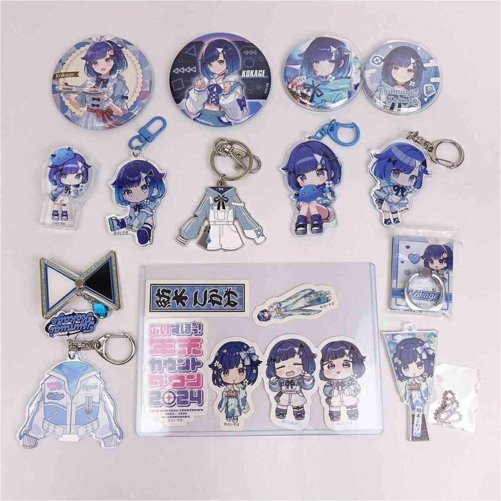 Blue-haired anime character merchandise spread: buttons, keychains, acrylic stands, stickers, and accessories in blue tones.