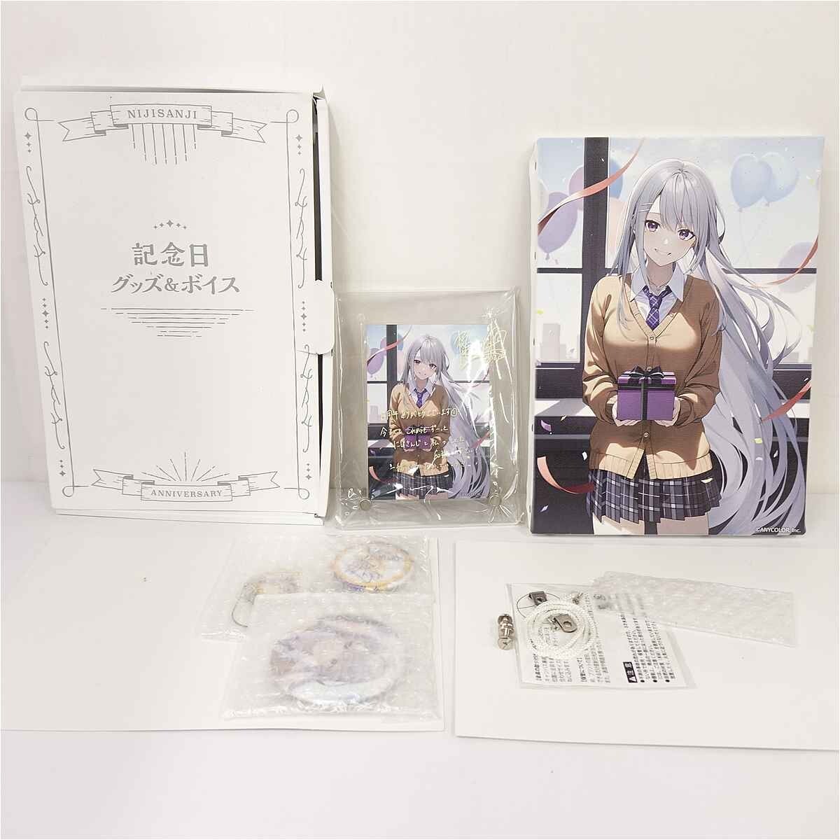 Anime merchandise set: large white Anniversary box, a small illustrated card in a plastic sleeve, and a tall art print of a silver-haired schoolgirl holding a purple gift.