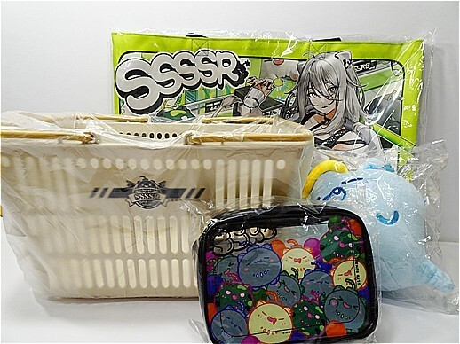 i-img518x388-17778618136828fmg8ot2263 1 | Vtuberグッズ買取専門店 Assorted anime merchandise: cream woven tote, black zip pouch with colorful circular designs, blue plush, and a bright green illustrated poster in the background.