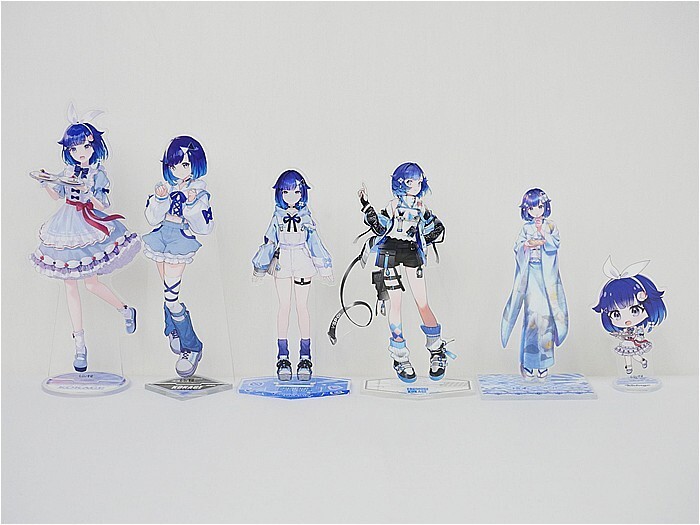 Six blue-haired anime character acrylic standees lined up on a white surface, each in a different outfit.