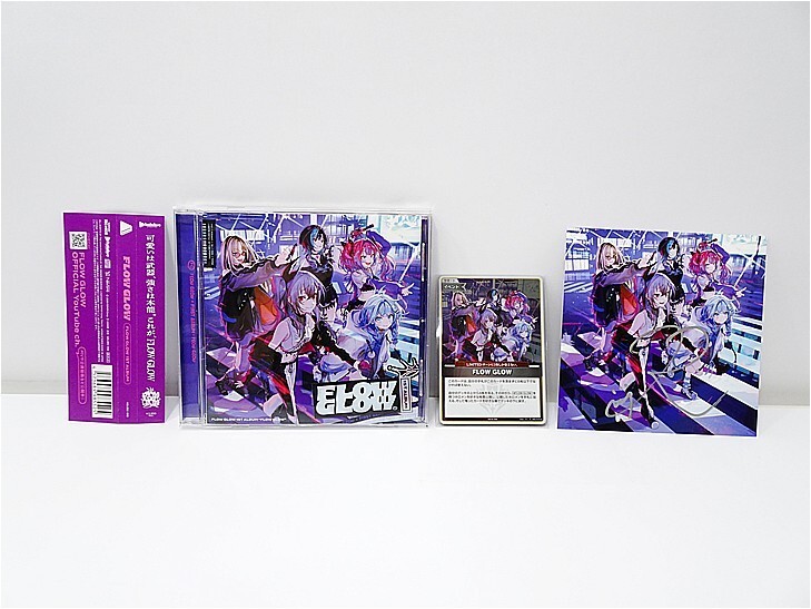 i-img729x547-17784921955996pwdqdy272929 | Vtuberグッズ買取専門店 Set of anime trading cards and packaging on a white surface: purple box, two art cases with character illustrations, and a poster farther right.