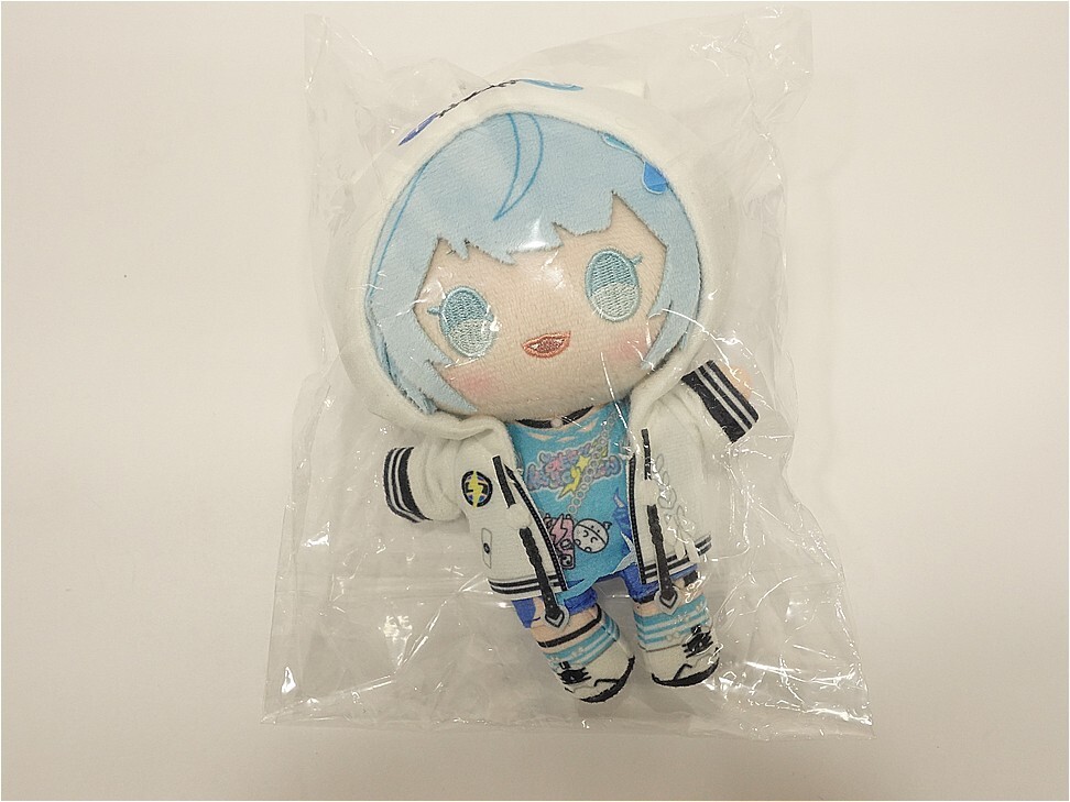 Soft plush doll with light blue hair in a white jacket and blue outfit, in clear plastic packaging.
