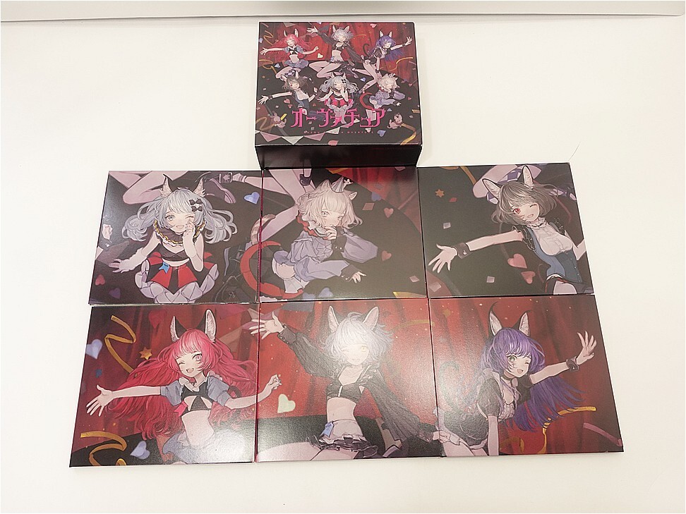 i-img972x729-17736375446028wud8dp173248 - Vtuberグッズ買取専門店Vtrader Row of nine square boxes with anime cat-ear characters printed on the front, arranged in a 3x3 grid with a single box on top center against a white wall.