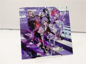 Five anime-style girls in colorful outfits pose on a purple stair-step backdrop, displayed on a clear stand.