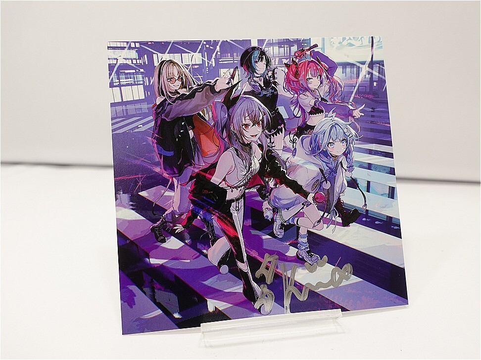 Five anime-style girls in colorful outfits pose on a purple stair-step backdrop, displayed on a clear stand.