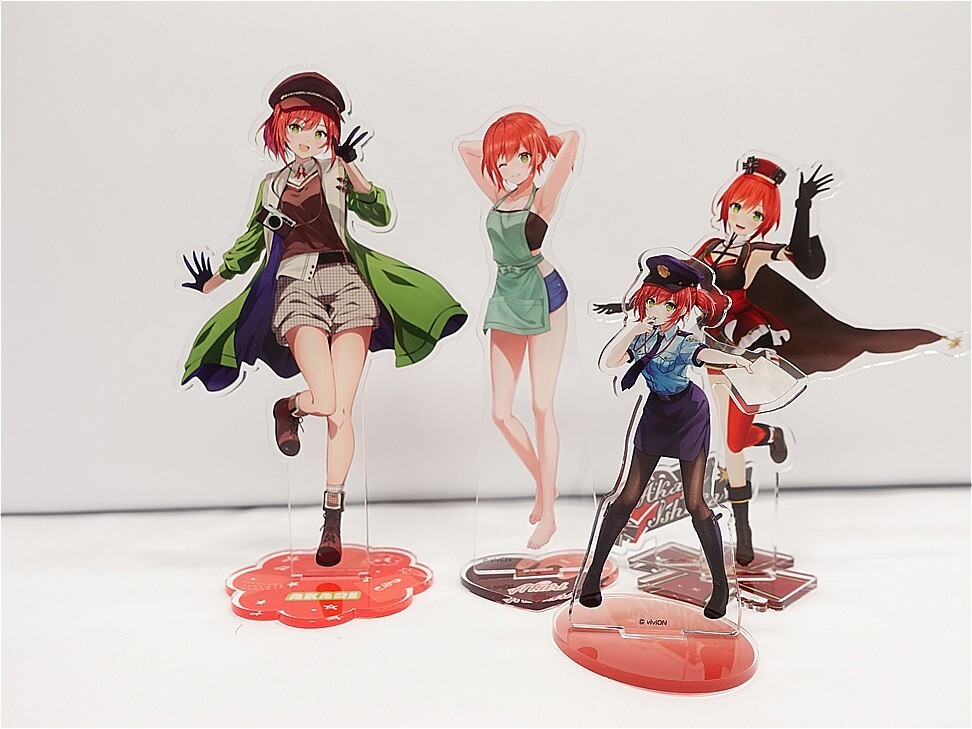 Set of four anime character standees with colorful outfits on red bases, posed dynamically on a white surface.