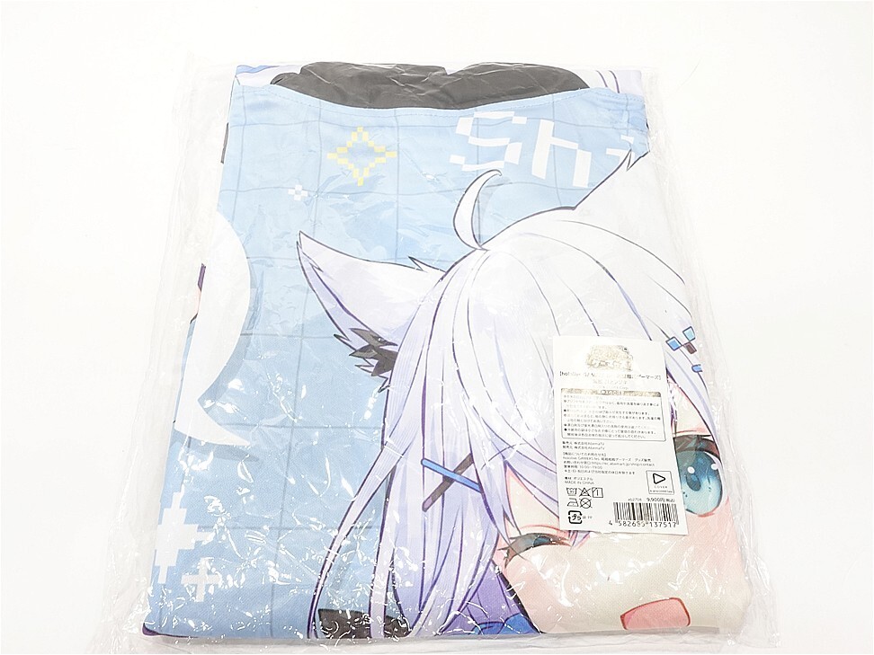 Folded blue anime-themed blanket with a white-haired character design, wrapped in plastic packaging.