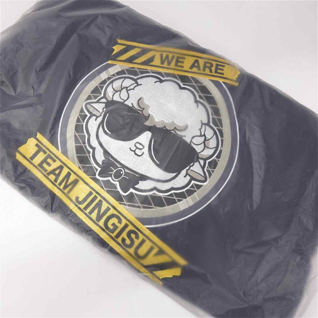 image - Vtuberグッズ買取専門店Vtrader Black plastic bag with a circular logo of a sheep wearing sunglasses, and yellow tape-style banners reading 'WE ARE' and 'TEAM JINGISU'.