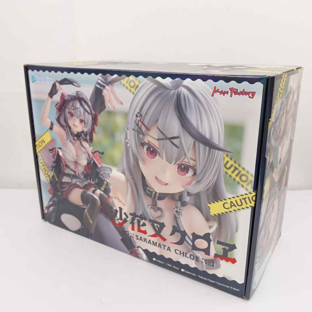 image - Vtuberグッズ買取専門店Vtrader Boxed anime figure packaging featuring a gray-haired chibi girl and yellow caution tape on the front.