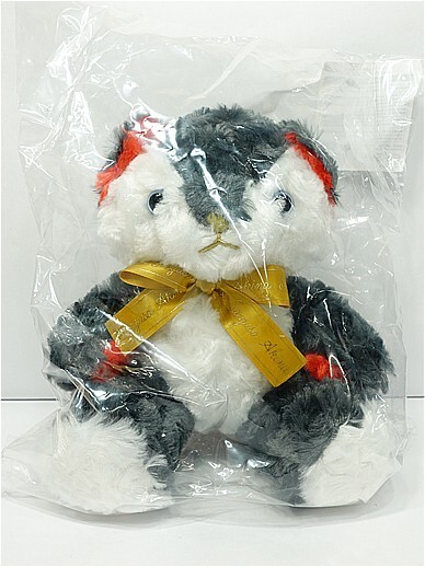 n12144069281 - Vtuberグッズ買取専門店Vtrader Soft panda plush toy with white and gray fur, red ears, and a gold ribbon bow, wrapped in clear plastic packaging for gifting