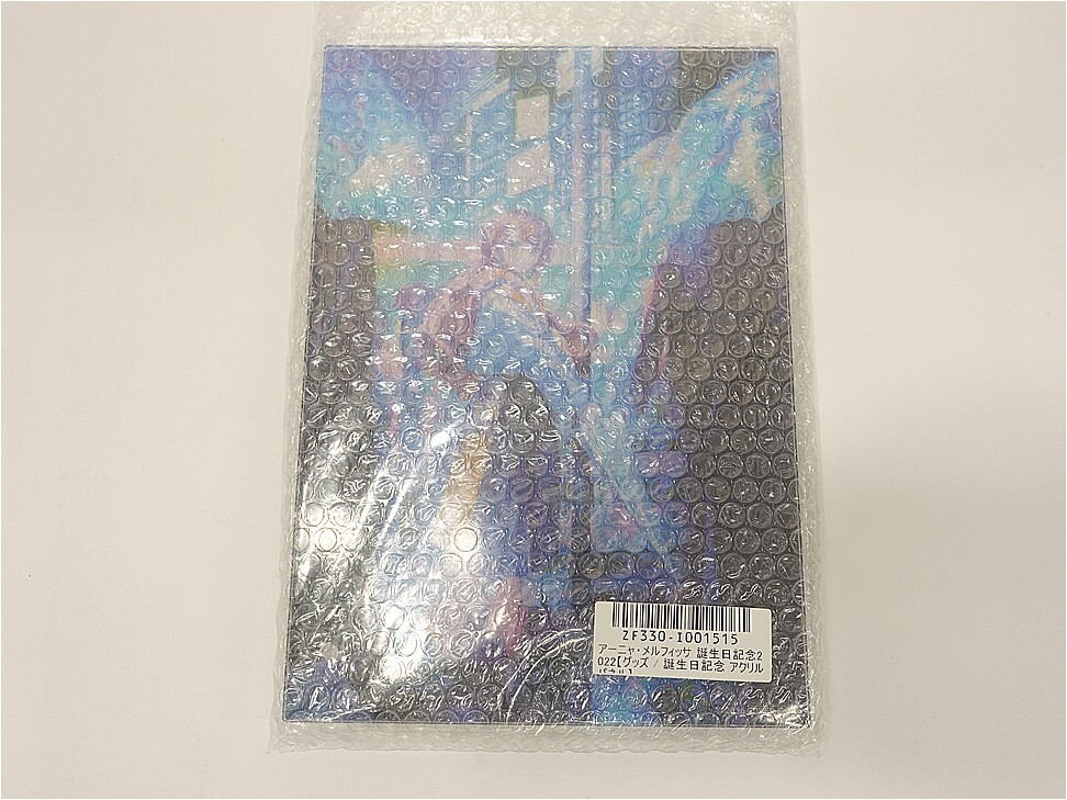 p12216239791 1 | Vtuberグッズ買取専門店 Colorful illustrated book wrapped in clear bubble wrap with a barcode sticker on the lower right corner