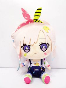 Soft plush doll with cream hair, purple eyes, and pink cheeks wearing blue overalls and colorful socks, sitting upright.