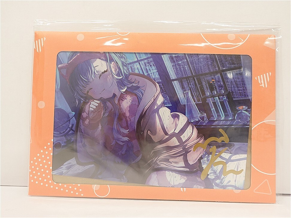 v12183155451 1 | Vtuberグッズ買取専門店 Anime-style illustration of a girl with pastel hair sleeping on a bed, framed by an orange packaging sleeve with decorative patterns.