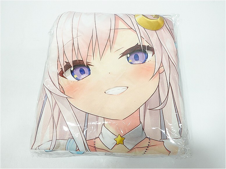 Square decorative pillow printed with a smiling anime girl's face, pink hair and blue eyes, wrapped in plastic.