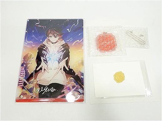 x12144127683 - Vtuberグッズ買取専門店Vtrader Merchandise set: art print of a character with glowing hands, plus bubble-wrapped red wax seal kit and a white card with a gold wax seal.